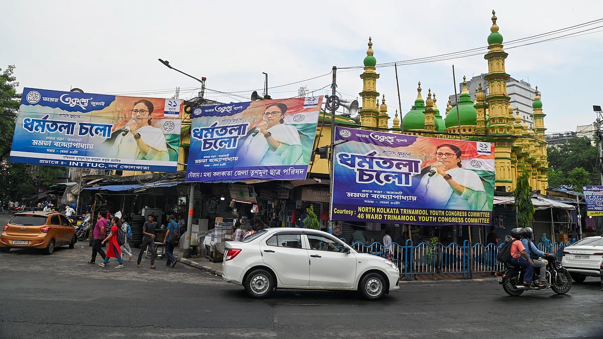 Vehicles move past the banners amid preparations for Martyr's Day rally in Kolkata (photo: PTI)