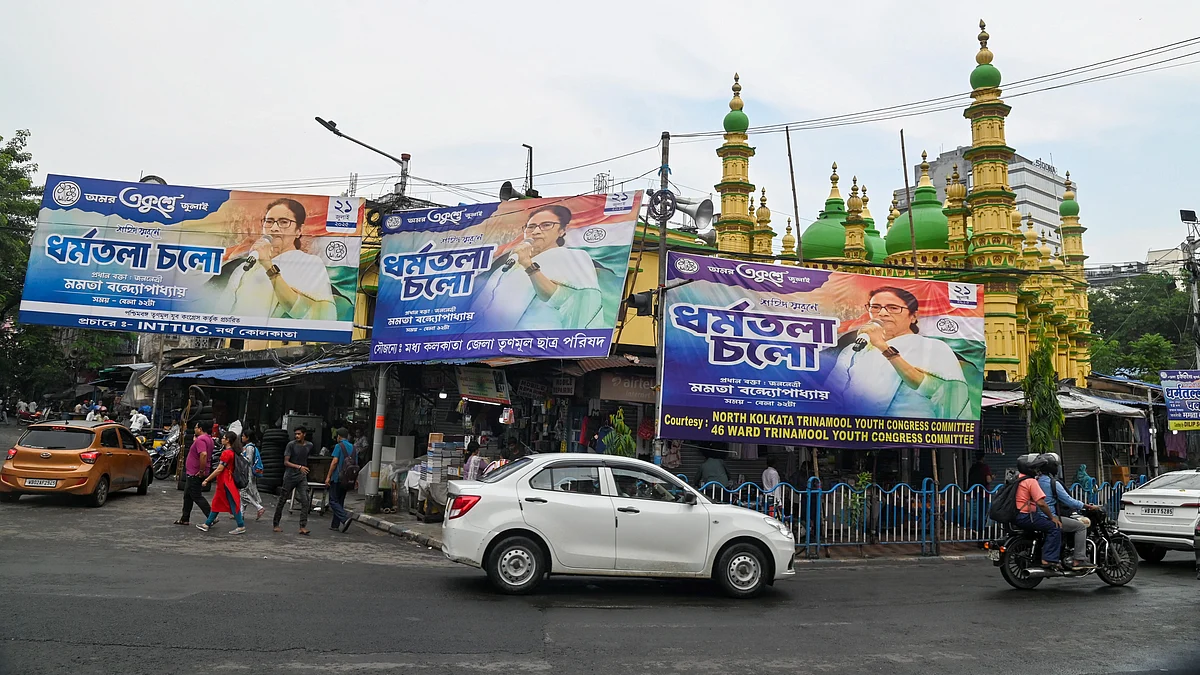 Vehicles move past the banners amid preparations for Martyr's Day rally in Kolkata (photo: PTI)