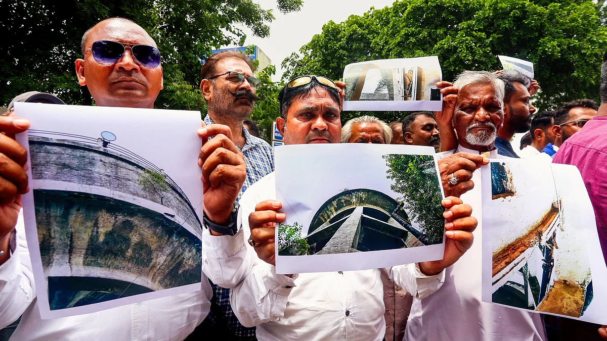 Protestors in Ahmedabad demand immediate removal of damaged bridges and water tanks (photo: PTI)