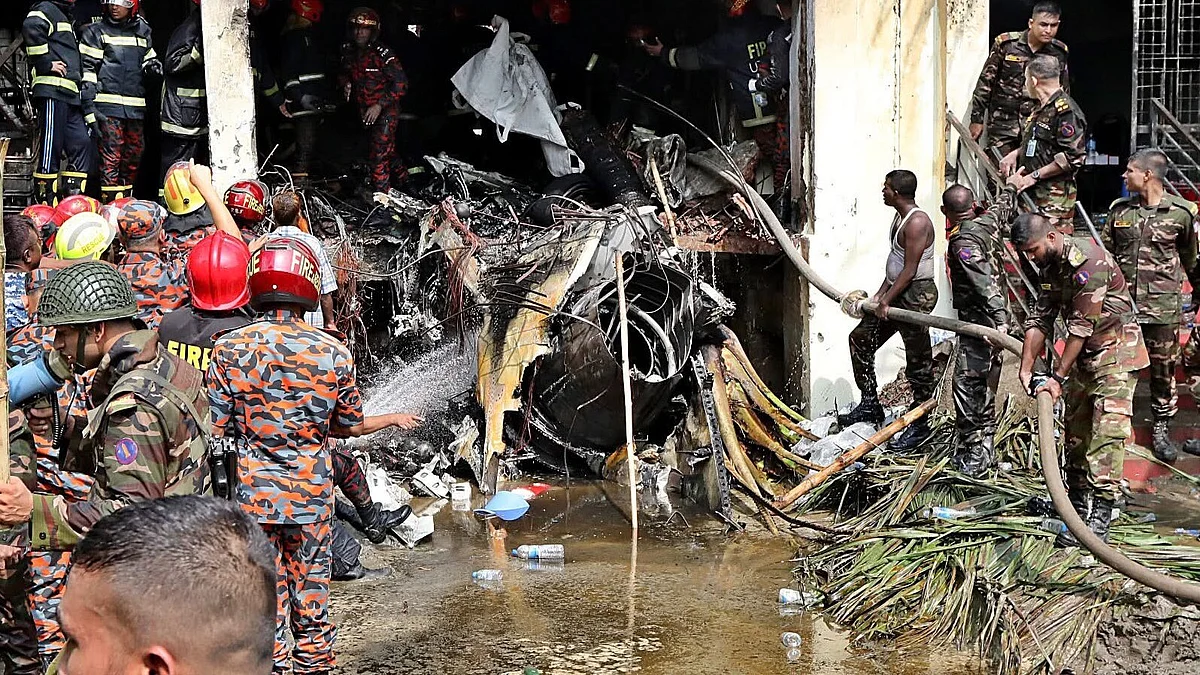 Firemen and military personnel work at the site in Dhaka on 21 July (photo: @mahjabeenkhaled/X)