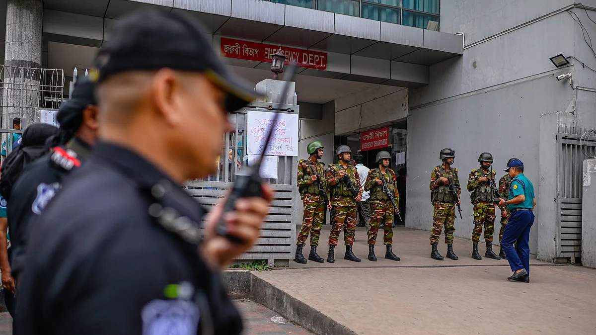 Personnel stand guard at the hospital where survivors are being treated in Dhaka (photo: AP/PTI)