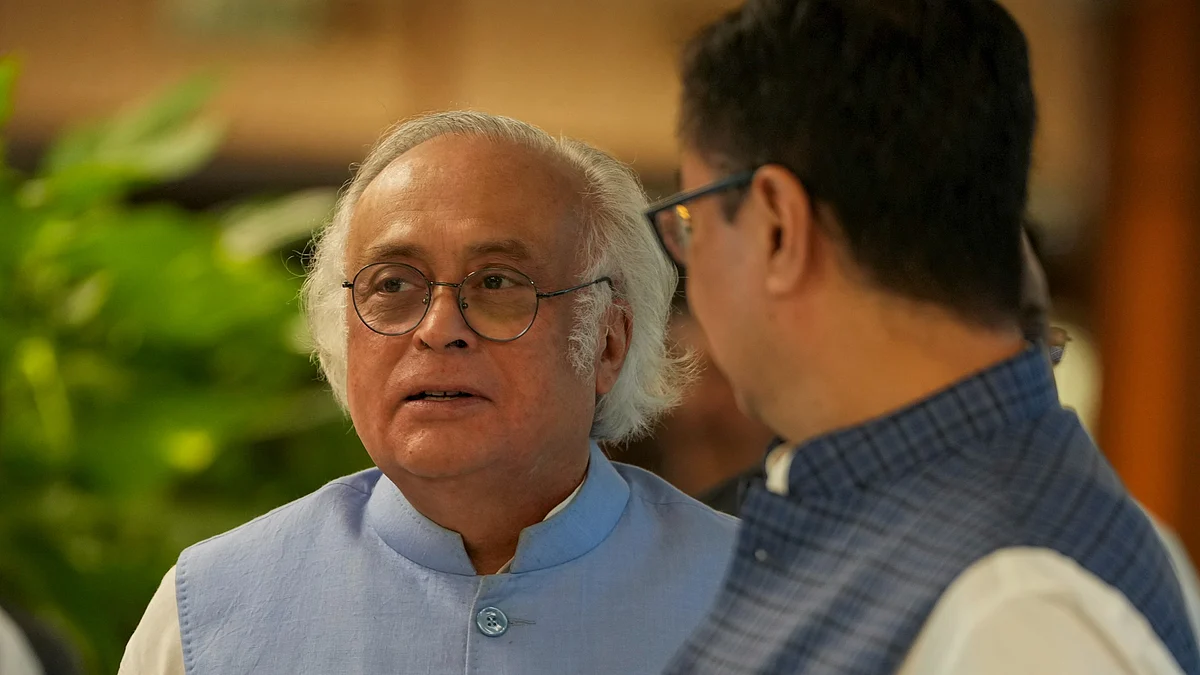 Kiren Rijiju and Jairam Ramesh at Parliament in New Delhi on 20 July (photo: PTI)