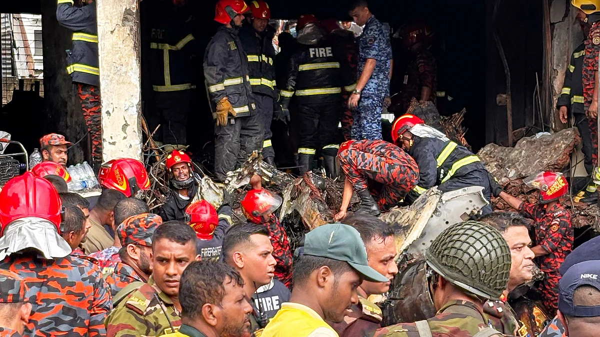 Firemen check the wreckage of Bangladesh Air Force training aircraft on 21 July (photo: AP/PTI)