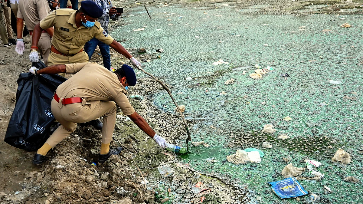 File photo of khaki-clad squads pulling trash from Sabarmati river in Ahmedabad