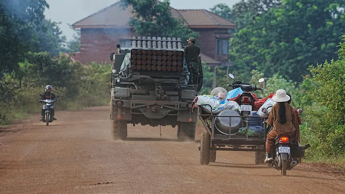 Cambodians drive behind a military vehicle in Cambodia on 25 July (photo: AP/PTI)