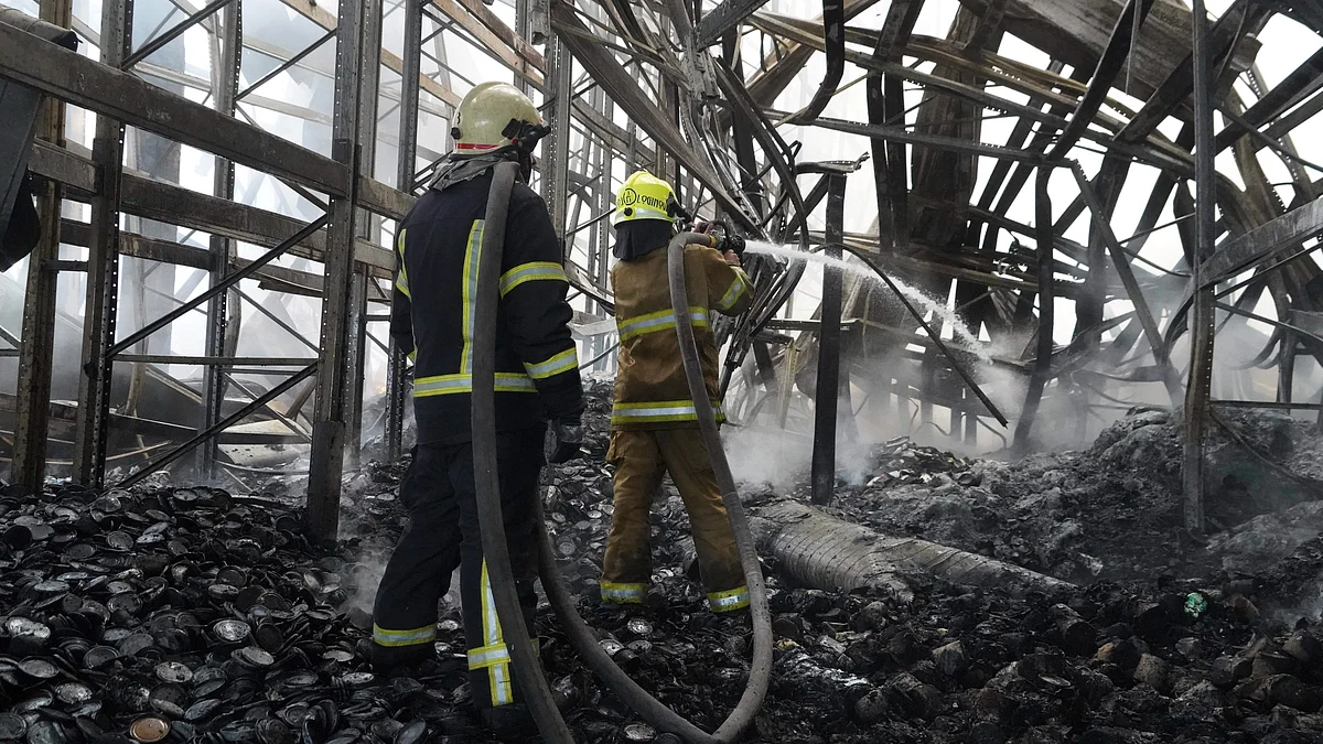 Firefighters tackle the blaze after a Russian attack in Kharkiv on 30 July (photo: AP/PTI)