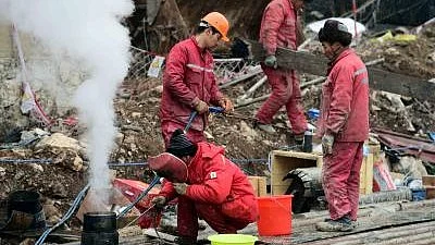 Rescue workers search for trapped miners at Chile's El Teniente copper mine (photo: IANS)