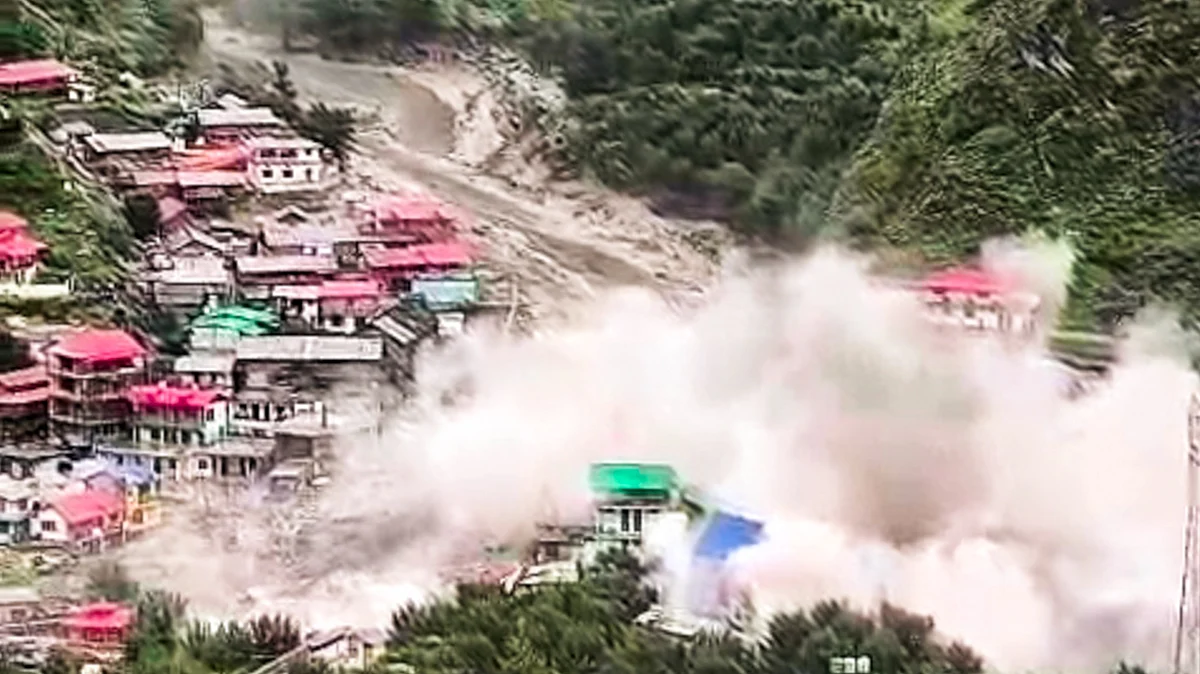 Houses being swept away in flash flood in Uttarkashi on 5 August (photo: PTI)