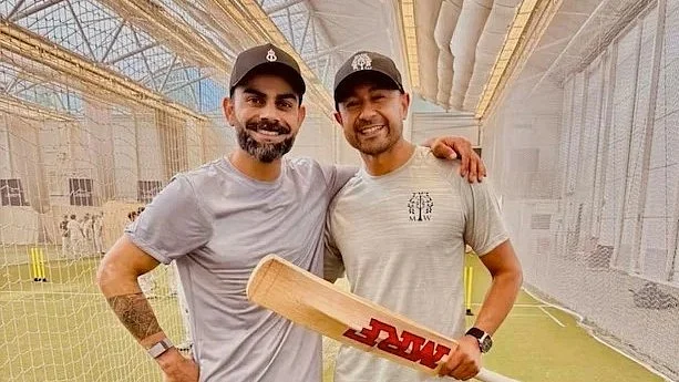 Virat Kohli with Naeem Amin, an IPL coach, after a training session in the UK