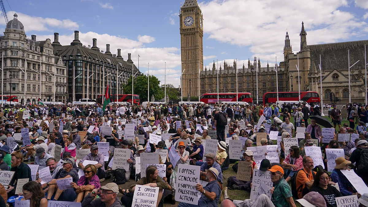 Demonstrators hold placards during a protest in London on 9 August