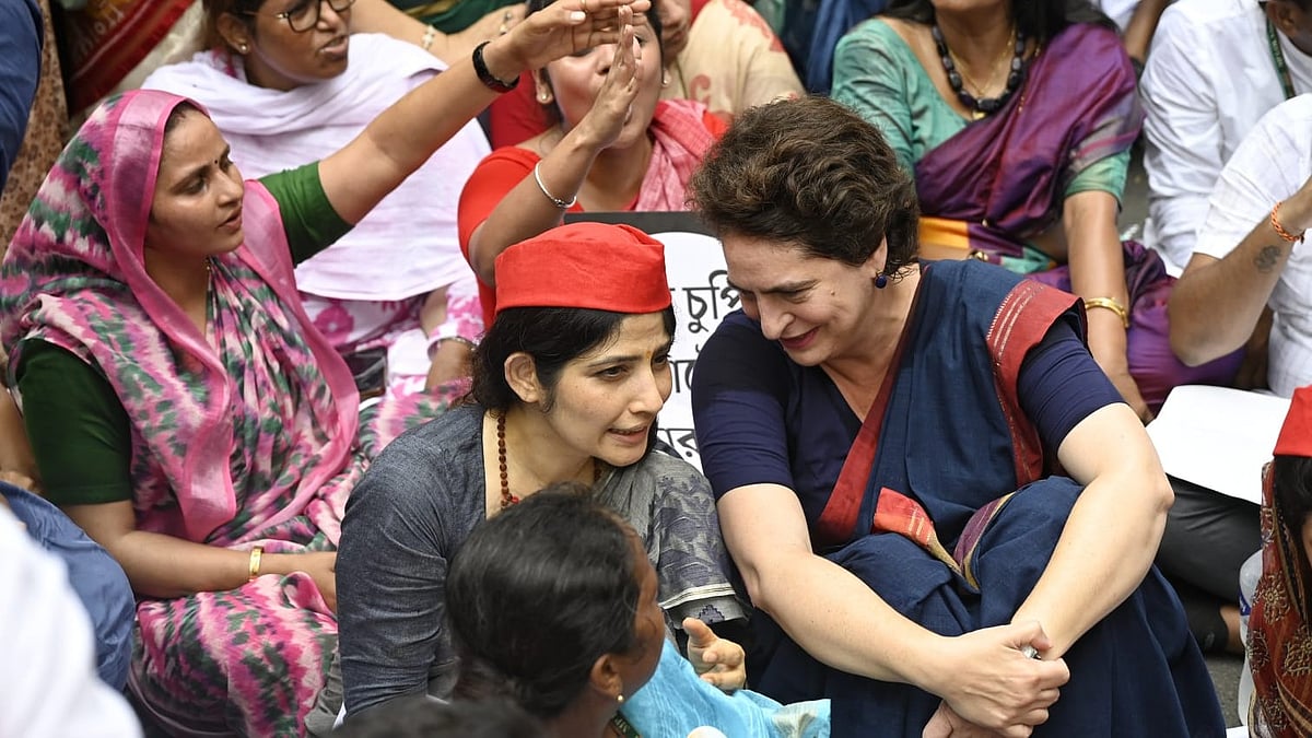 Priyanka Gandhi speaks to a party worker during the protest.
