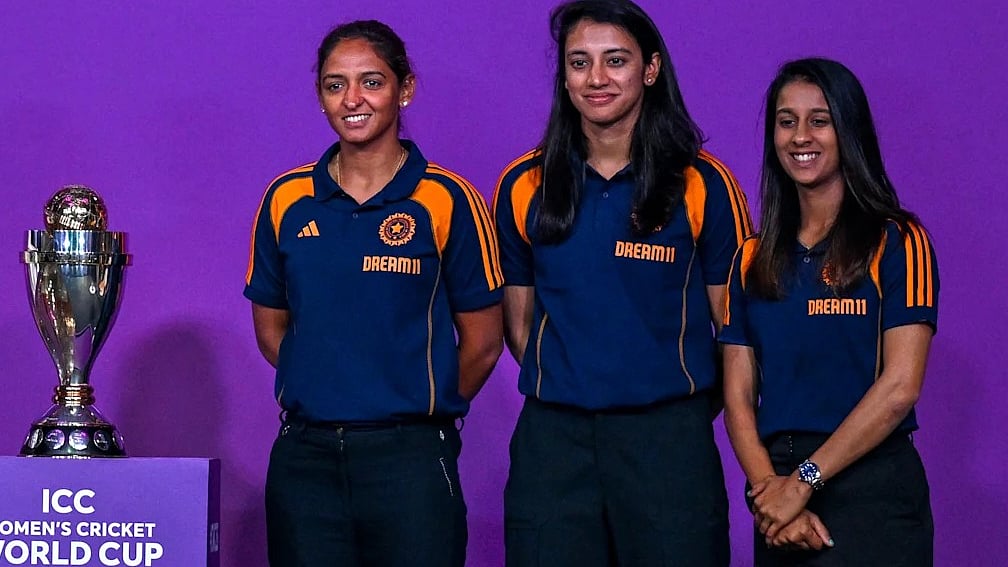 Captain Harmanpreet Kaur (left), Smriti Mandhana and Jemima Rodrigues with the World Cup trophy