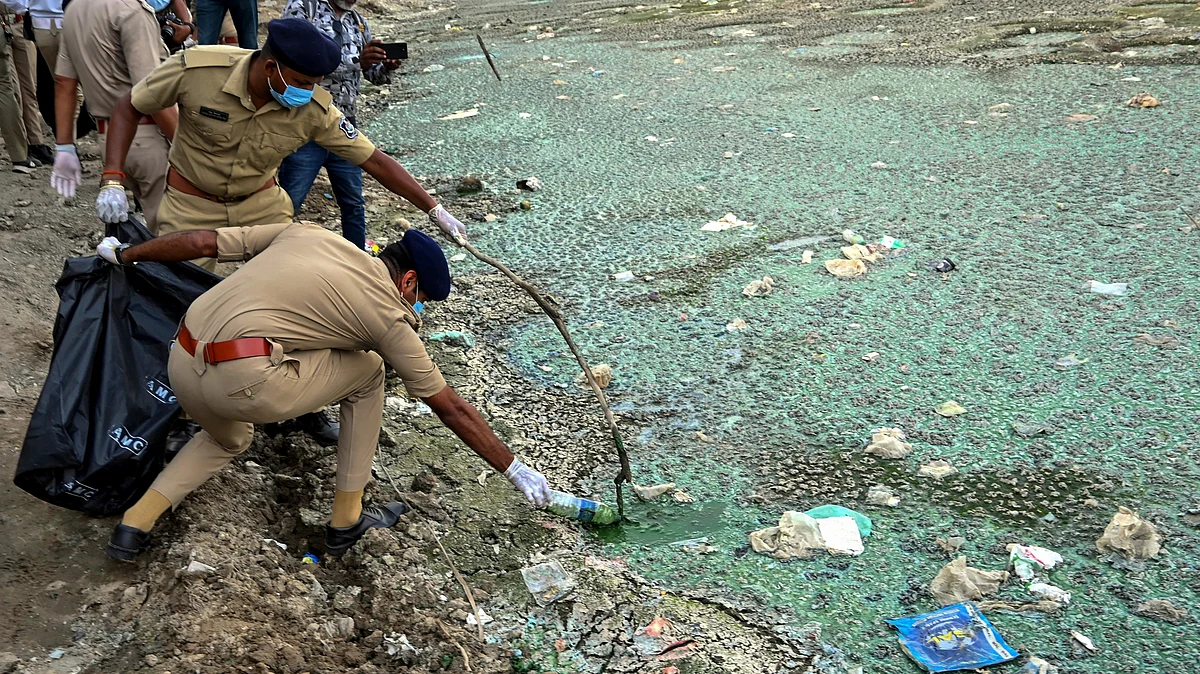 Policing plastic pollution: Khaki-clad squads pull trash from the Sabarmati river in Ahmedabad, Gujarat