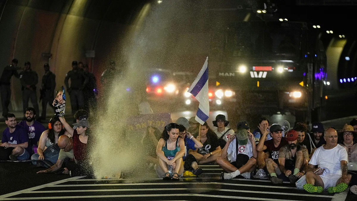 Police use water cannons to disperse protesters blocking a road in Jerusalem, 17 August
