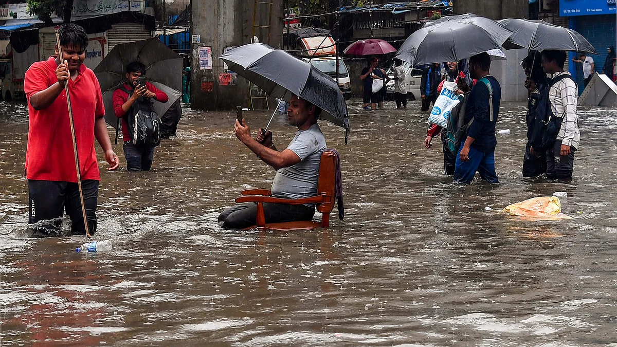 Selfie time in the middle of a flooded Mumbai road. (photo: PTI)