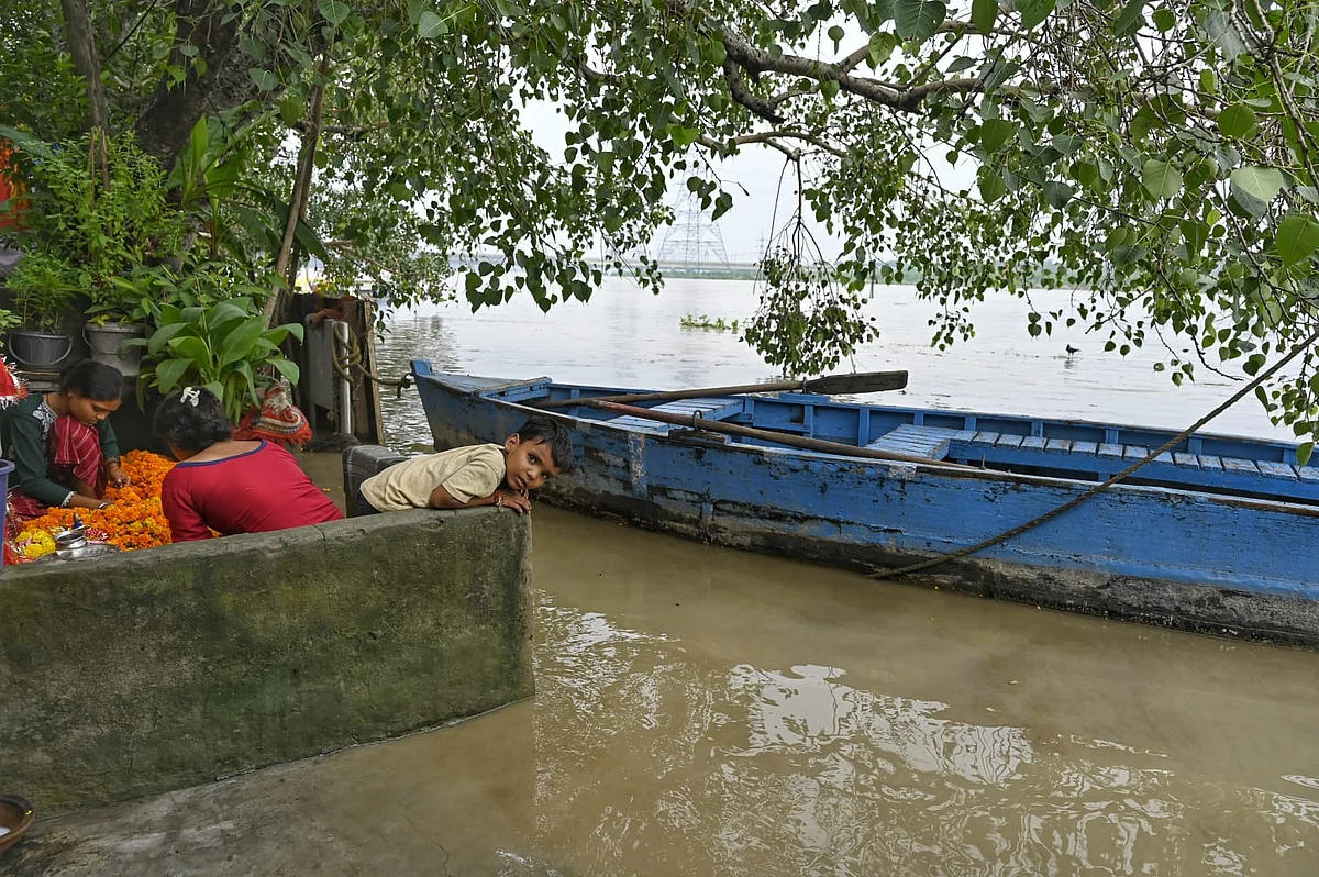 Residents of the Yamuna floodplains in Delhi look out over their now very watery neighbourhood from 'safety'