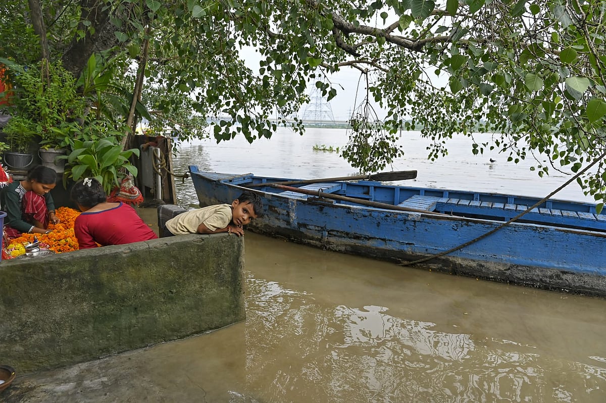 Residents of the Yamuna floodplains in Delhi look out over their now very watery neighbourhood from 'safety'
