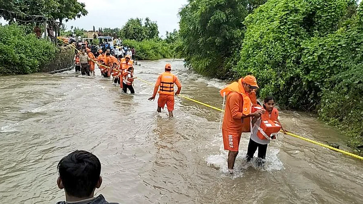 NDRF personnel rescue stranded people from a flood-affected area in Gujarat