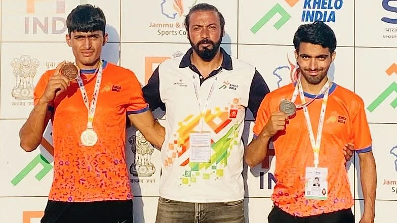 SAI coach Zulfkar Ali Bhat with two of his medal-winning wards