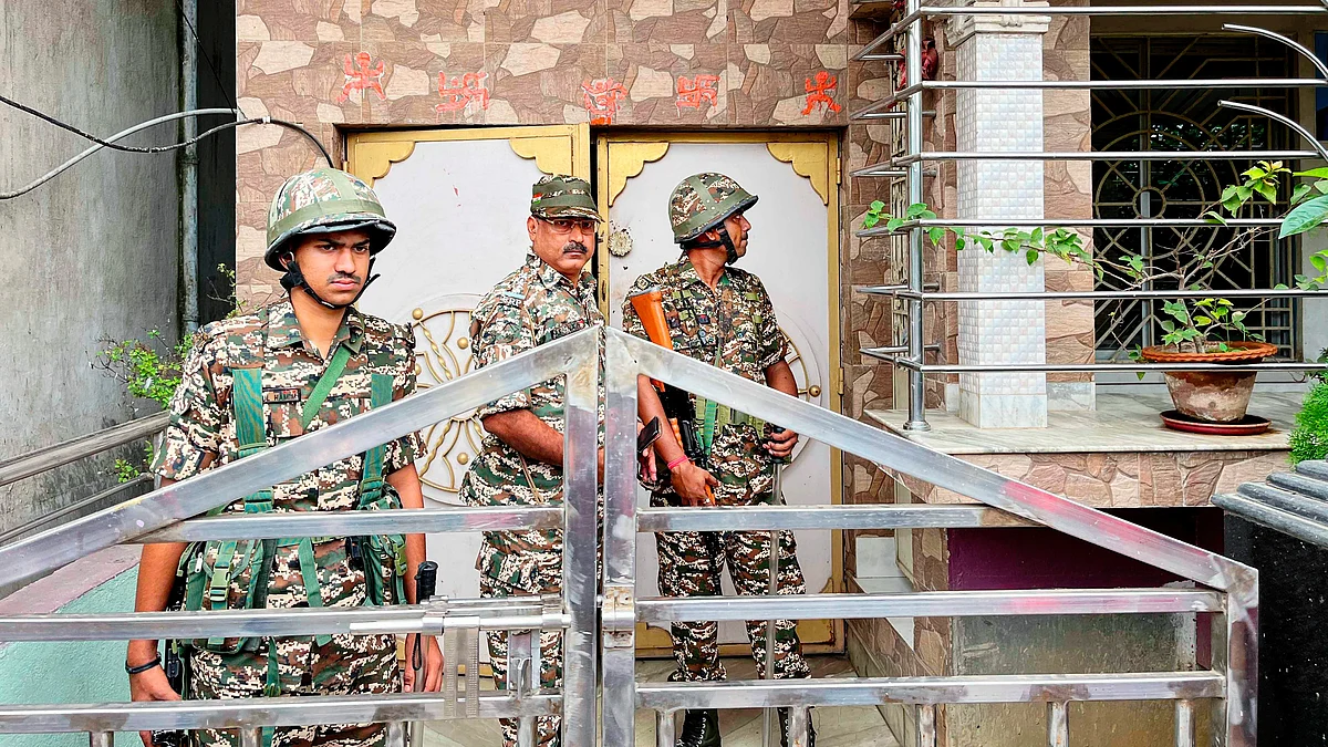 Security personnel at the residence of a relative of TMC MLA Jiban Krishna Saha, during an ED raid