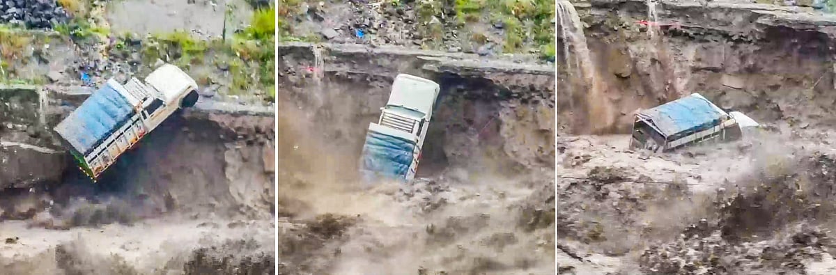 A pick-up van swept away in a landslide triggered by a raging river, in Manali, 26 Aug