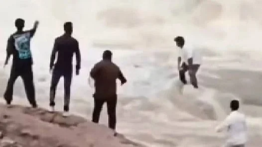 A video grab shows the moment when the YouTuber was swept away.
