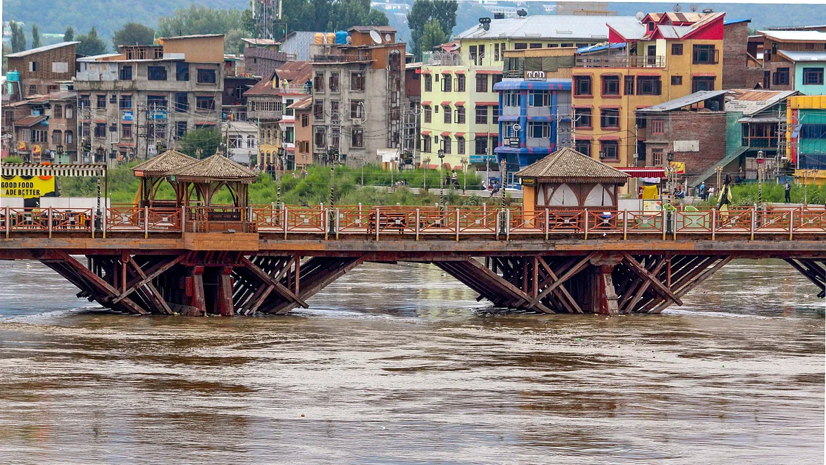 The Jhelum river flows above the danger mark in Srinagar. (Photo: PTI)