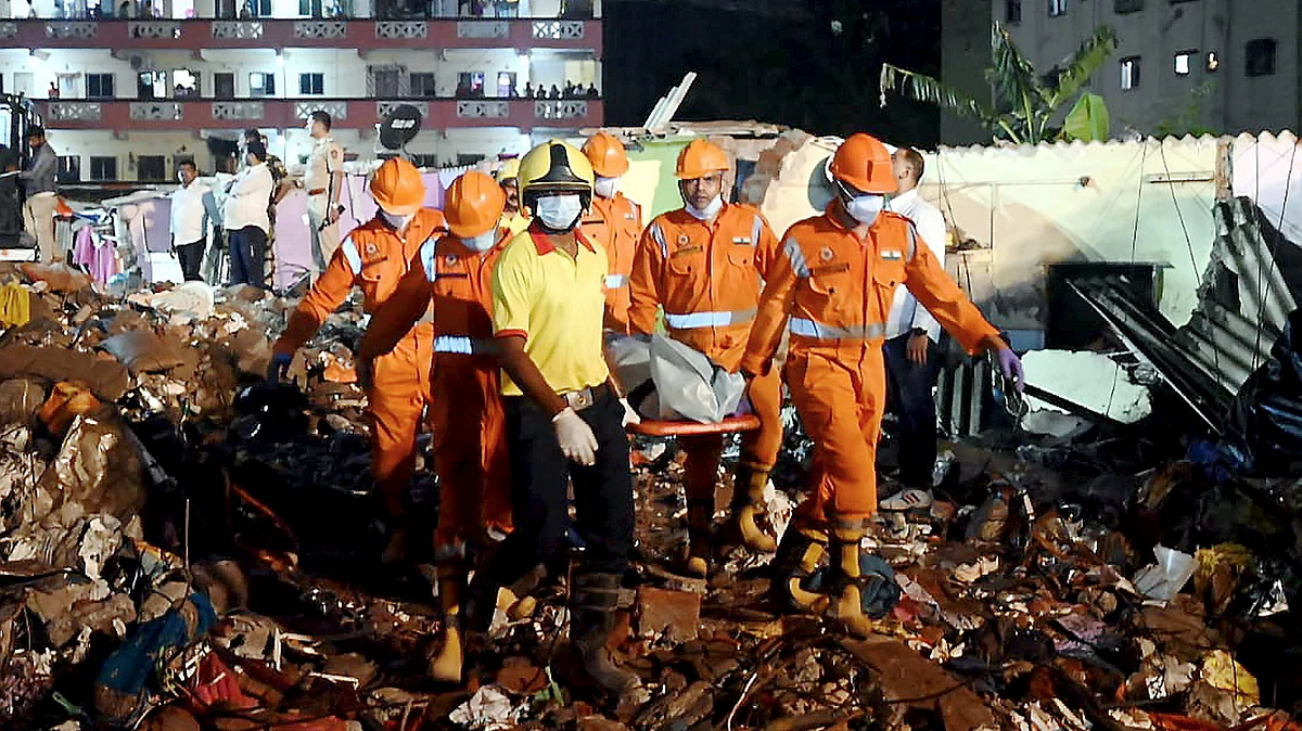 NDRF personnel carry a body retrieved from the rubble in Palghar