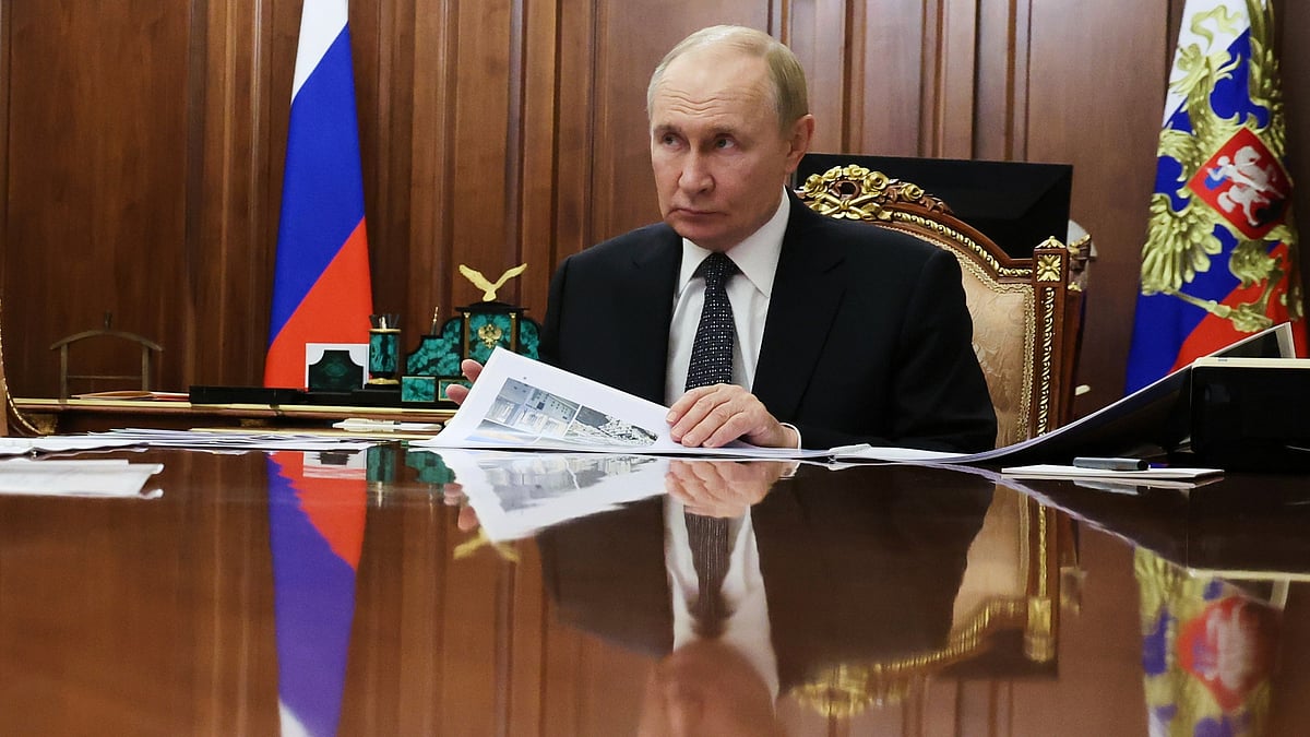Vladimir Putin attends a meeting at Kremlin