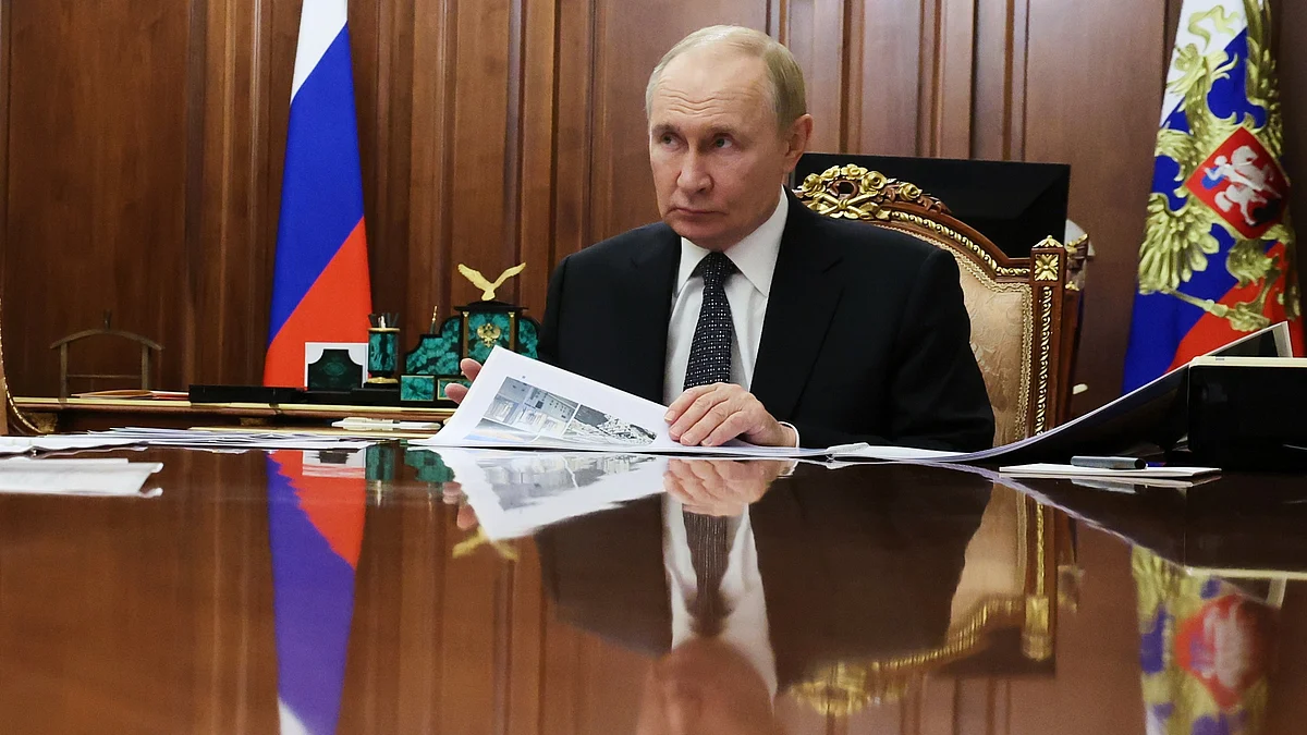 Vladimir Putin attends a meeting at Kremlin