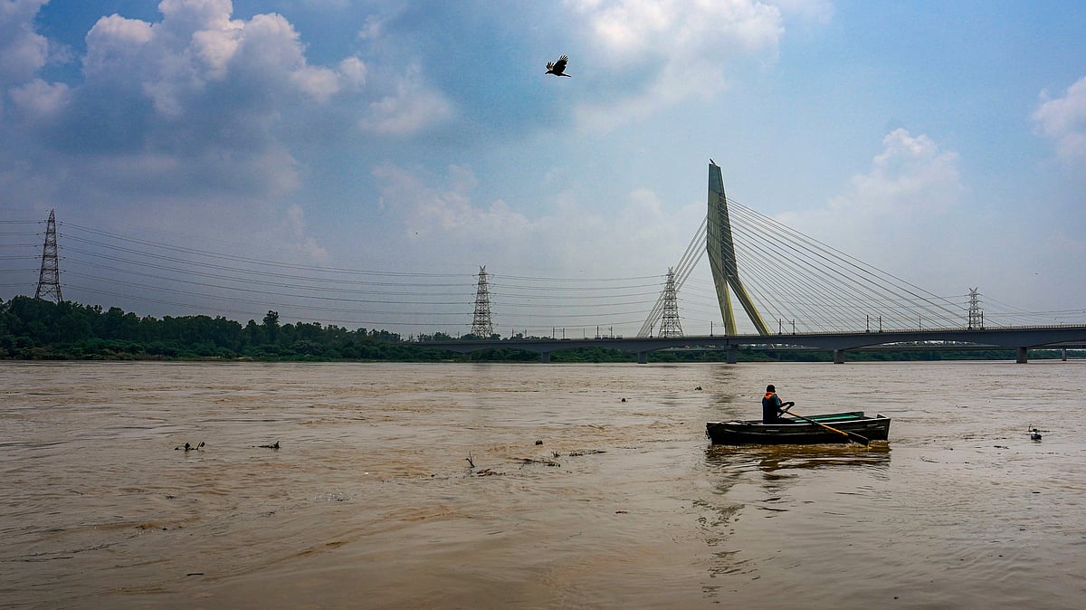 Man rows across the flooded Yamuna at Wazirabad