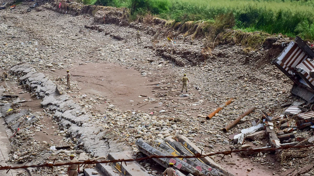 Police officials at a flood-affected stretch of Tawi river in Jammu