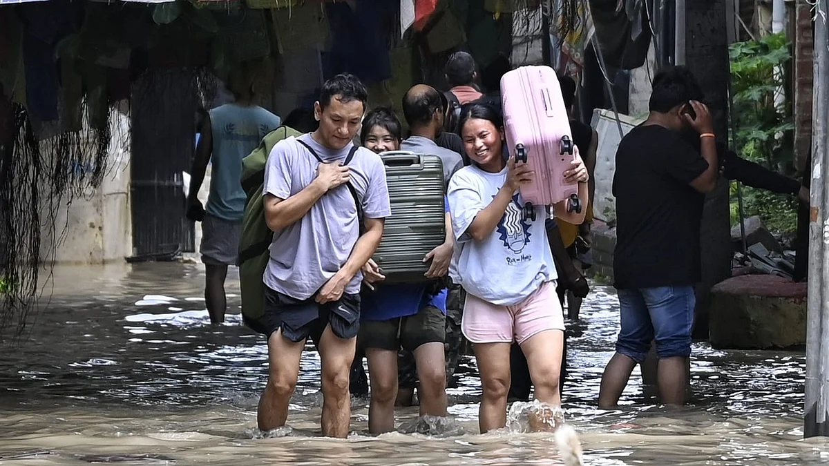 Residents carry their belongings from flooded houses as the Yamuna rose above the danger mark