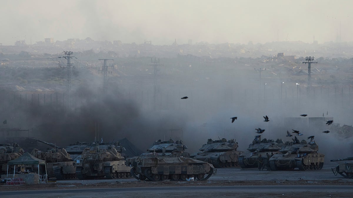 Israeli soldiers prepare a tank near the Gaza border amid escalating tensions
