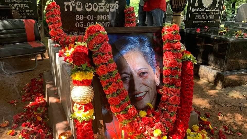 Floral tributes, in bright communist red and green, garland the last memorial to Gauri Lankesh