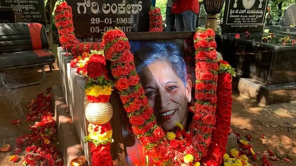 Floral tributes, in bright communist red and green, garland the last memorial to Gauri Lankesh