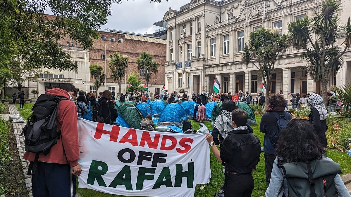 QUML students' encamped on the college lawns, with Palestinian flags and a banner: 'Hands off Rafah'