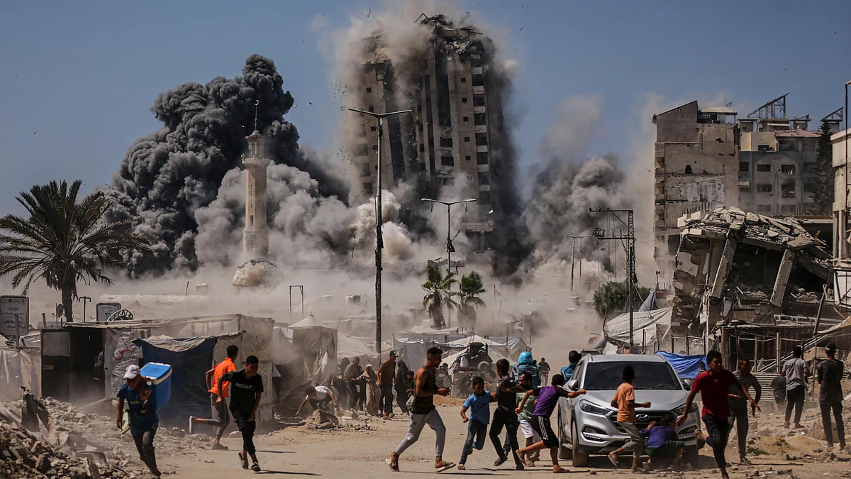 Palestinians run for cover during an Israeli airstrike in Gaza City