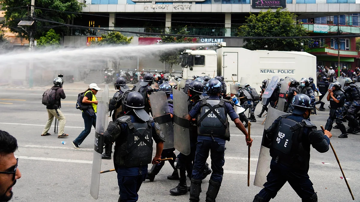 Riot police clash with protesters outside the Parliament building in Kathmandu