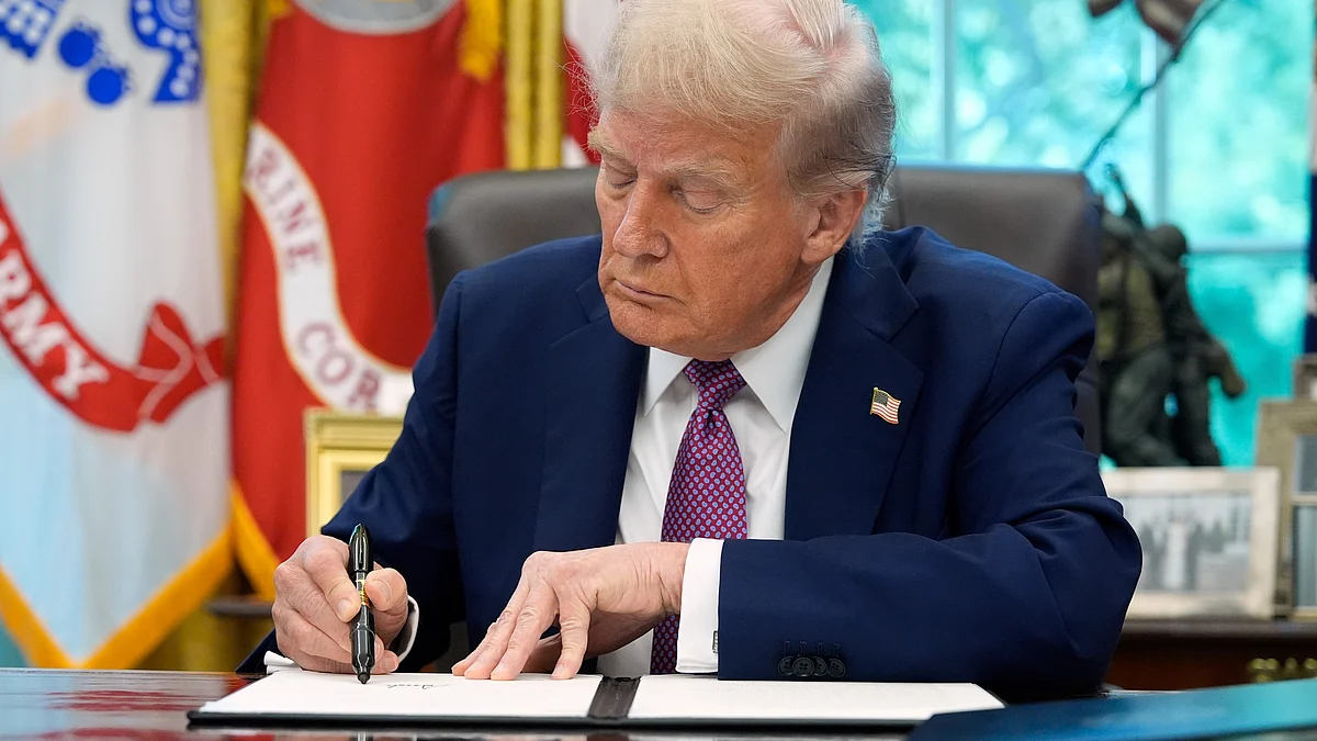 Donald Trump signs an executive order at Oval Office