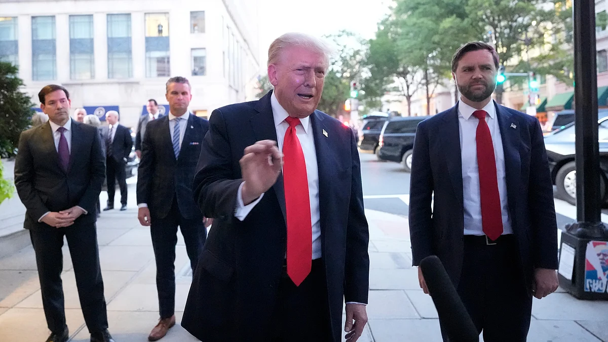 Donald Trump addresses reporters outside a White House-area restaurant.