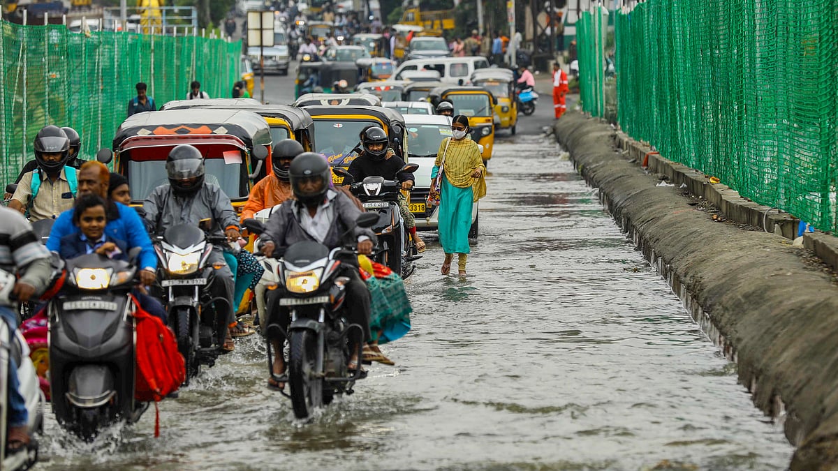 Motorists and pedestrians wade through waterlogged streets in Hyderabad.