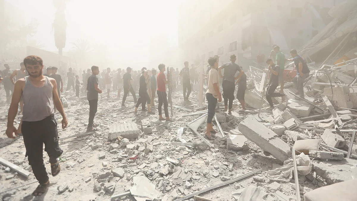 Palestinians inspect the rubble of a building after an Israeli strike in Gaza City, 14 Sep