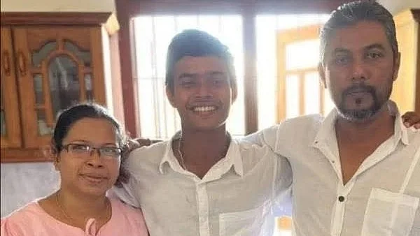 File photo of Dunith Wellalage being flanked by father Suranga and mother