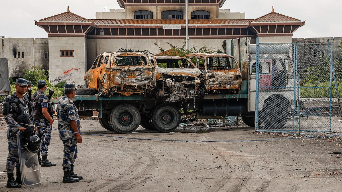 Charred remains of vehicles outside Nepal’s Parliament as protests turn violent in Kathmandu