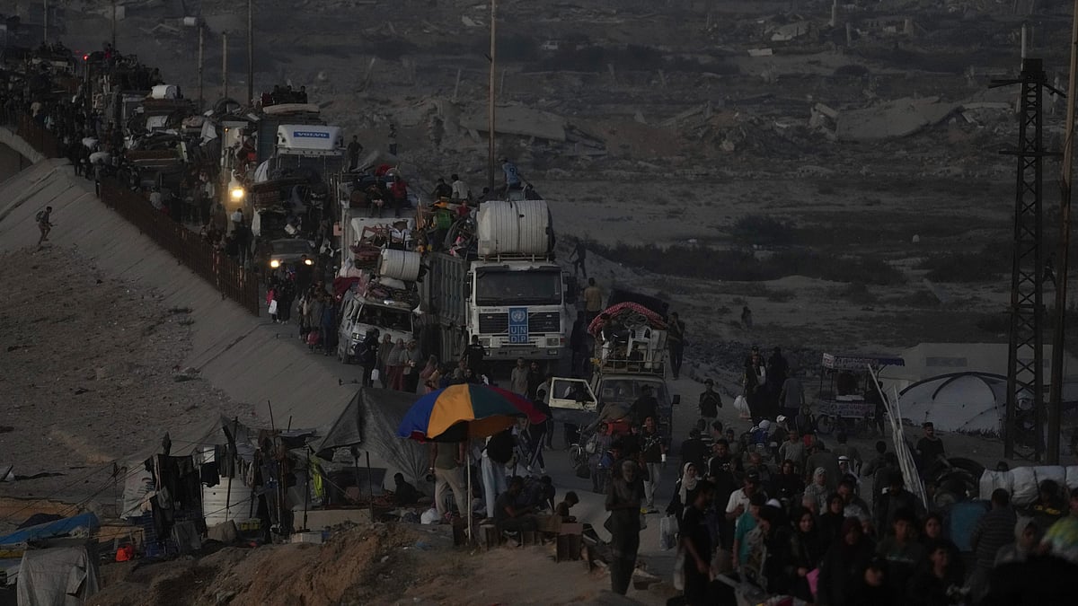 Displaced Palestinians flee Gaza City with belongings on 19 September