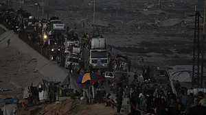 Displaced Palestinians flee Gaza City with belongings on 19 September
