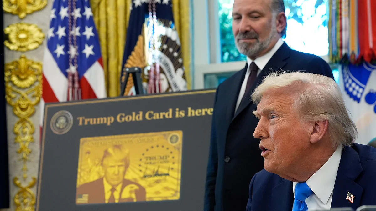 Trump speaks in Oval Office as commerce secretary Lutnick listens.