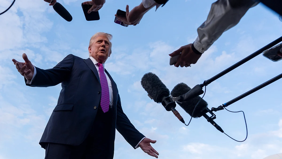 President Donald Trump speaks with reporters before he departs on Air Force One