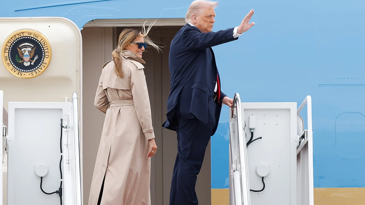 Donald Trump waves from the stairs of Air Force One